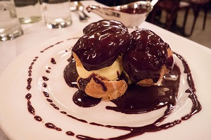 Ralph had the profiteroles with vanilla ice cream and chocolate sauce Balthazar New York